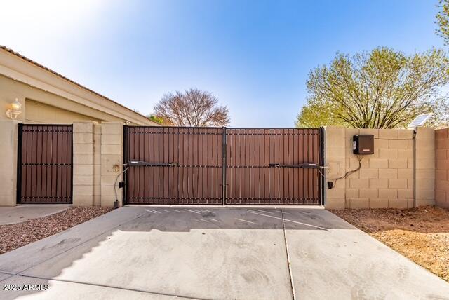 view of gate with fence