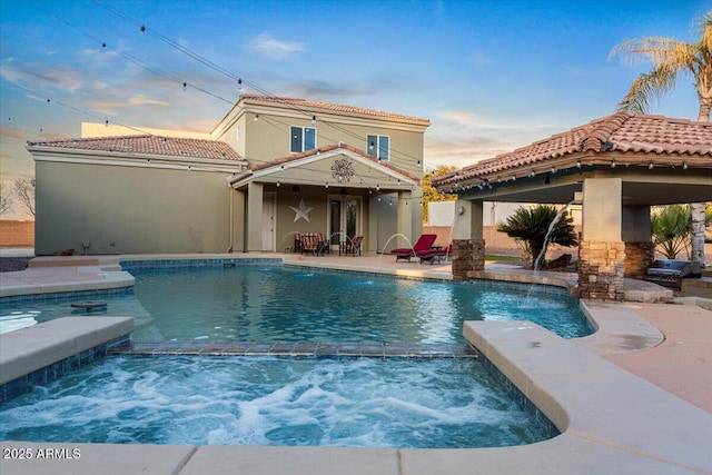 view of swimming pool with a pool with connected hot tub and a patio