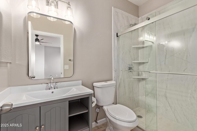 bathroom with toilet, a marble finish shower, a ceiling fan, and vanity