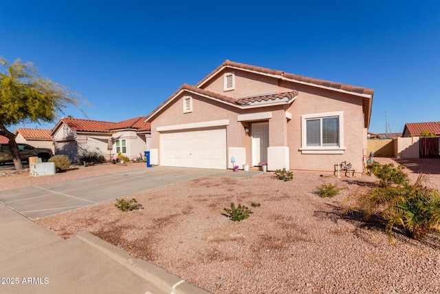 mediterranean / spanish-style house featuring driveway, a tiled roof, an attached garage, fence, and stucco siding