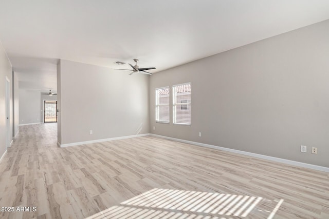 unfurnished room featuring light wood-style flooring, visible vents, baseboards, and a ceiling fan