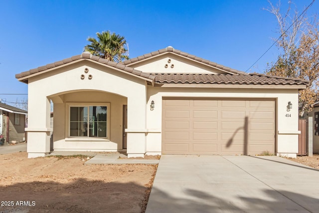 mediterranean / spanish-style house with a garage and covered porch