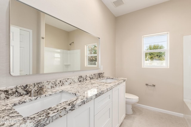 bathroom featuring toilet, a shower, and vanity