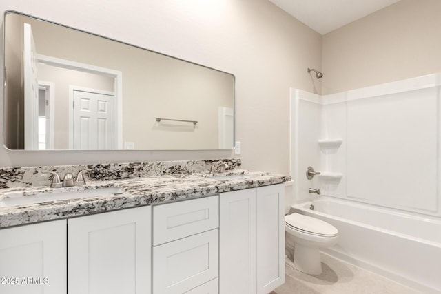 full bathroom featuring washtub / shower combination, toilet, and vanity