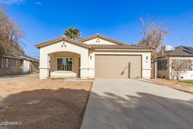 mediterranean / spanish-style home featuring a garage