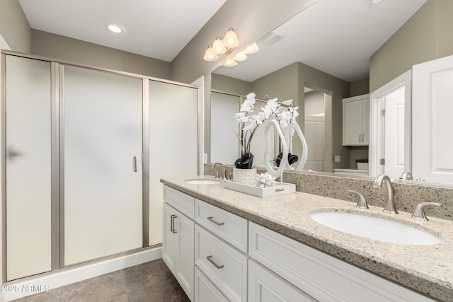 36145 N Desert Tea Dr, Queen Creek, AZ 85140 - full bathroom featuring a stall shower, double vanity, and tile patterned flooring