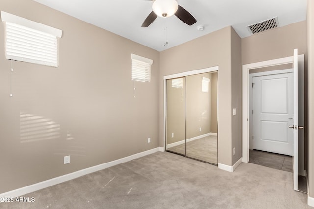 36145 N Desert Tea Dr, Queen Creek, AZ 85140 - unfurnished bedroom with light colored carpet, a closet, baseboards, and a ceiling fan
