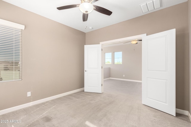 36145 N Desert Tea Dr, Queen Creek, AZ 85140 - spare room featuring a ceiling fan, light colored carpet, and baseboards