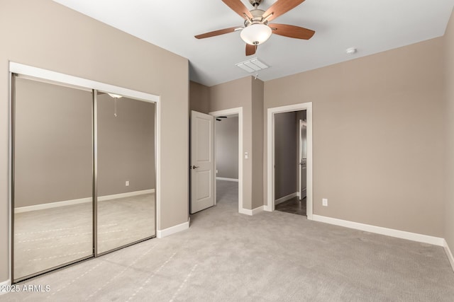 36145 N Desert Tea Dr, Queen Creek, AZ 85140 - unfurnished bedroom featuring light carpet, baseboards, a closet, and ceiling fan