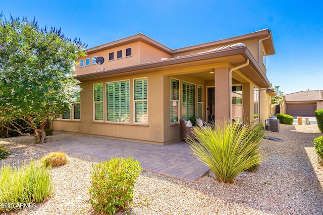 36145 N Desert Tea Dr, Queen Creek, AZ 85140 - rear view of house featuring stucco siding and a patio
