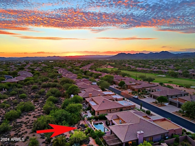 aerial view at dusk featuring a mountain view