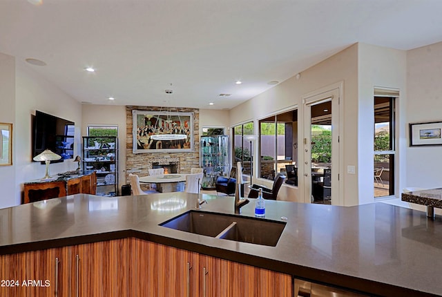 kitchen featuring a fireplace and sink