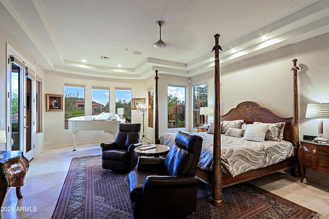 tiled bedroom featuring a tray ceiling