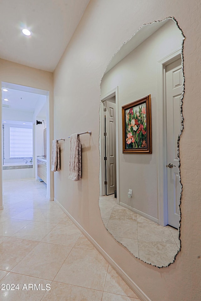 hall featuring light tile patterned flooring