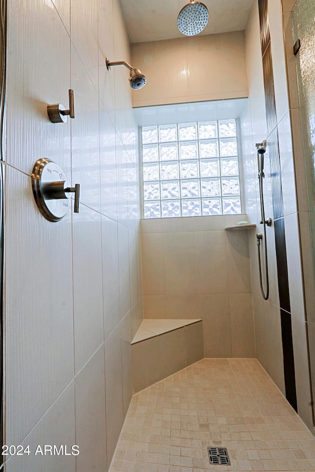 bathroom with a tile shower