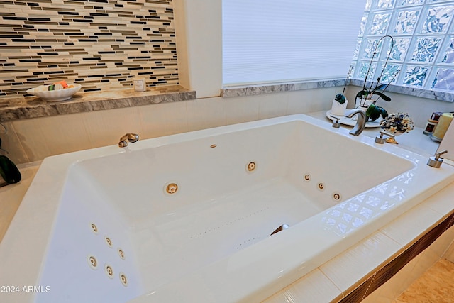 bathroom with a tub to relax in