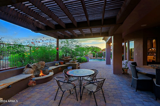 patio terrace at dusk featuring a pergola