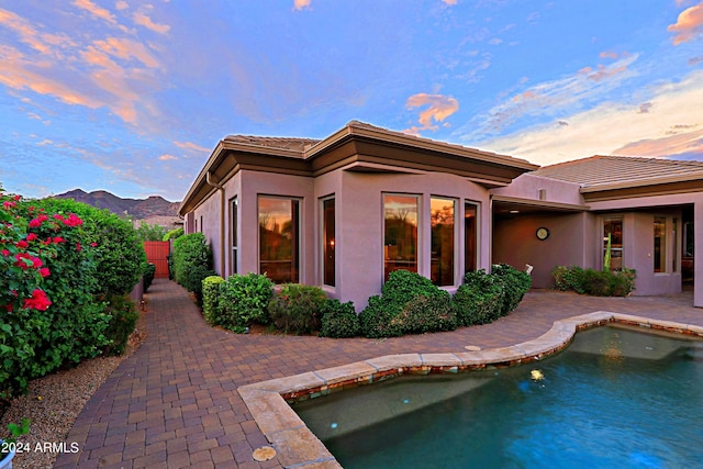 back house at dusk featuring a mountain view