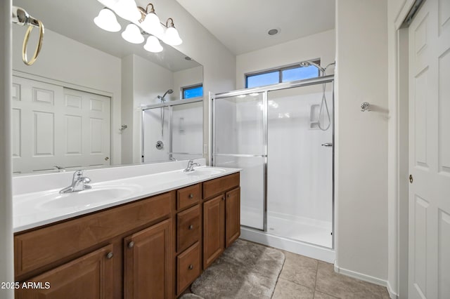 bathroom featuring a sink, tile patterned floors, a shower stall, and double vanity