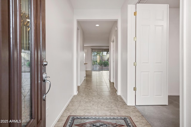 foyer entrance with recessed lighting, baseboards, and light tile patterned floors