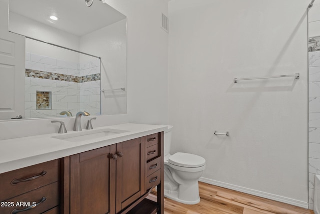 full bath featuring visible vents, walk in shower, toilet, wood finished floors, and vanity