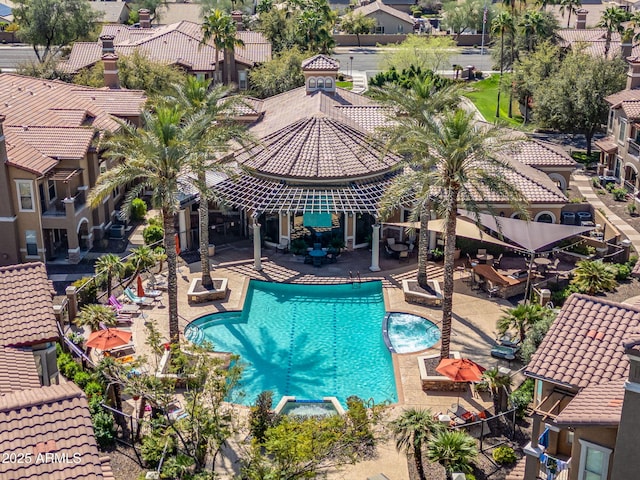 pool featuring a patio area and a residential view