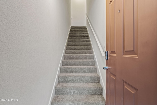 staircase with a textured wall