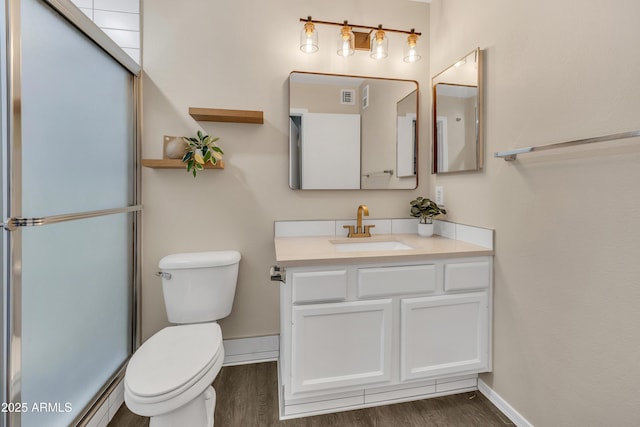5808 E Brown Rd Unit 49, Mesa, AZ 85205 - bathroom featuring toilet, wood finished floors, vanity, and baseboards