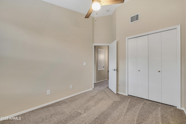 5808 E Brown Rd Unit 49, Mesa, AZ 85205 - unfurnished bedroom with carpet floors, baseboards, a closet, a towering ceiling, and a ceiling fan