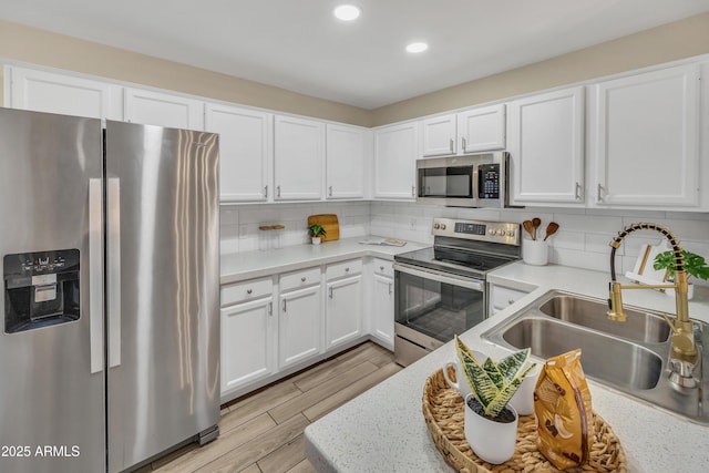 5808 E Brown Rd Unit 49, Mesa, AZ 85205 - kitchen featuring appliances with stainless steel finishes, a sink, light countertops, recessed lighting, and white cabinetry