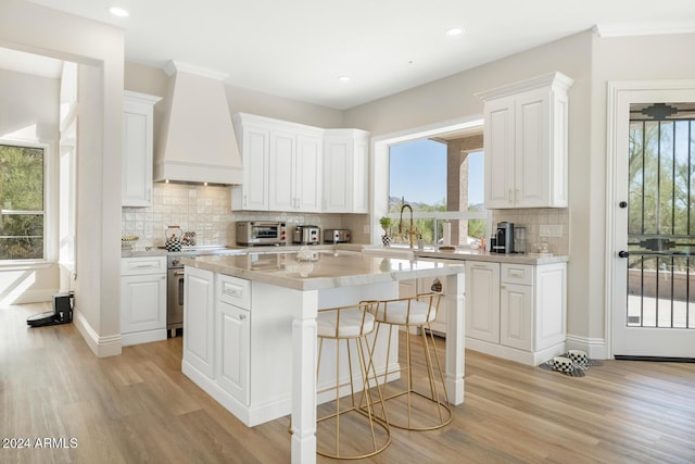 8757 E Lariat Ln, Scottsdale, AZ 85255 - kitchen featuring premium range hood, high end stainless steel range oven, light wood-style flooring, light countertops, and recessed lighting