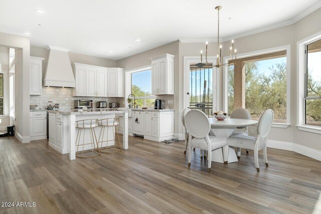 8757 E Lariat Ln, Scottsdale, AZ 85255 - dining space with a chandelier, light wood finished floors, recessed lighting, baseboards, and crown molding