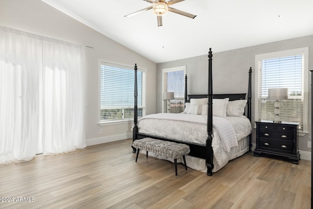 bedroom with ceiling fan, lofted ceiling, multiple windows, and light wood-type flooring