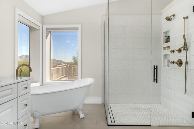 bathroom featuring vanity, lofted ceiling, independent shower and bath, and tile patterned floors