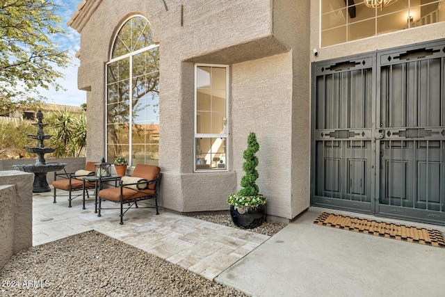 view of exterior entry featuring a patio