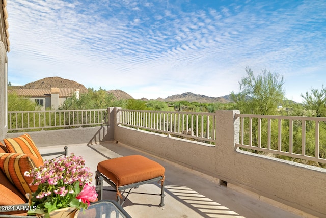 view of patio / terrace with a balcony and a mountain view