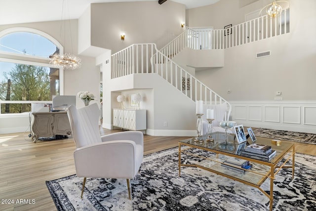 8757 E Lariat Ln, Scottsdale, AZ 85255 - living room with high vaulted ceiling, a chandelier, stairway, wood finished floors, and baseboards