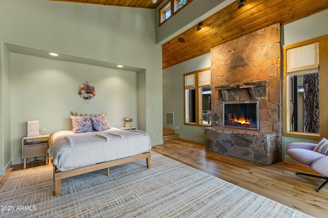 2096 William Palmer, Flagstaff, AZ 86005 - bedroom with wood ceiling, a stone fireplace, wood finished floors, baseboards, and a high ceiling
