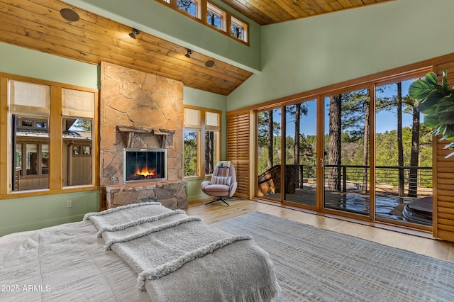 2096 William Palmer, Flagstaff, AZ 86005 - bedroom with wood finished floors, a fireplace, high vaulted ceiling, access to outside, and wood ceiling