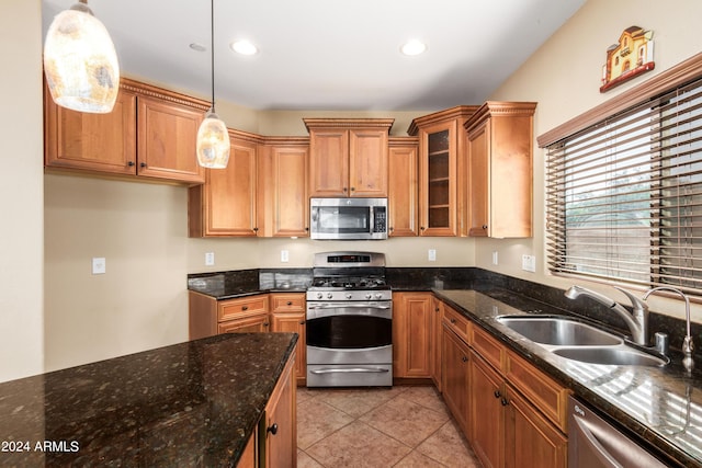 kitchen with light tile patterned floors, recessed lighting, a sink, appliances with stainless steel finishes, and decorative light fixtures