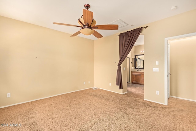 unfurnished room featuring light carpet, ceiling fan, and baseboards