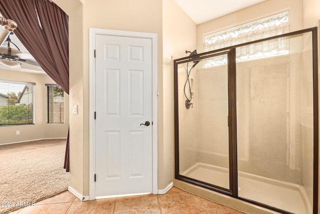 bathroom featuring a stall shower, tile patterned flooring, and baseboards