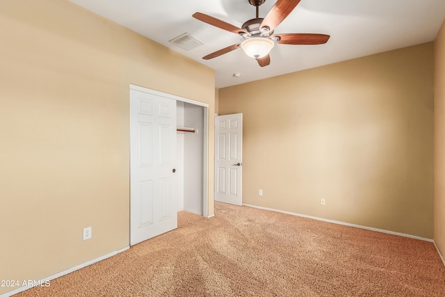 unfurnished bedroom featuring a closet, carpet flooring, visible vents, and baseboards