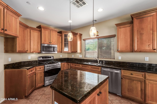 kitchen featuring brown cabinets, visible vents, stainless steel appliances, and a sink