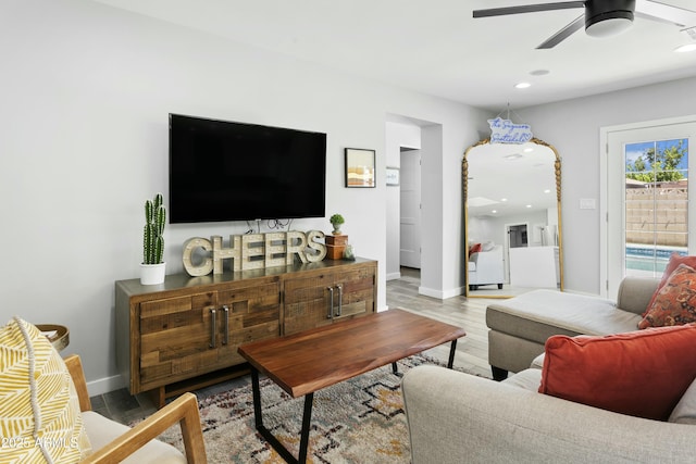 living room featuring recessed lighting, ceiling fan, baseboards, and wood finished floors