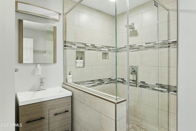 bathroom with a stall shower and vanity