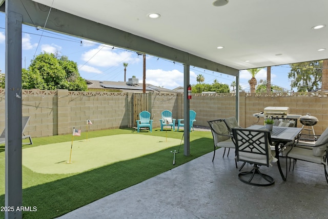 view of patio featuring outdoor dining space and a fenced backyard