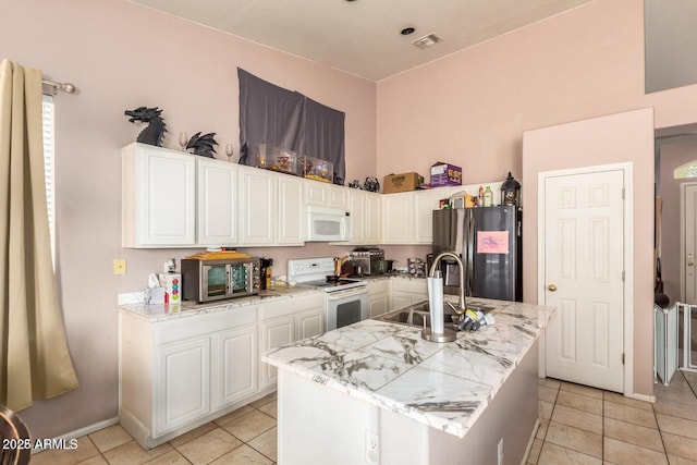 kitchen featuring white cabinetry, appliances with stainless steel finishes, and a kitchen island with sink