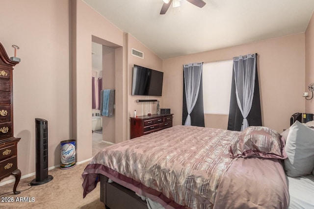 carpeted bedroom with ceiling fan, connected bathroom, and vaulted ceiling