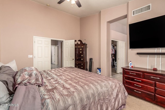 bedroom with a towering ceiling, ceiling fan, and a closet